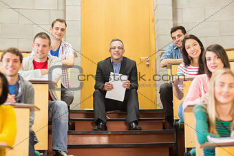 Elegant teacher with students sitting at the lecture hall