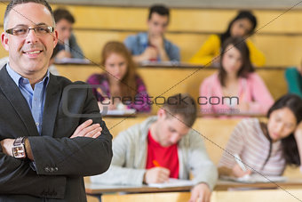 Elegant teacher with students sitting at lecture hall