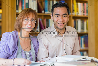 Adult students studying together in the library