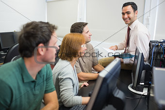 Teacher and mature students in computer room