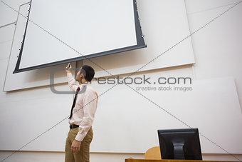 Teacher with projection screen in lecture hall