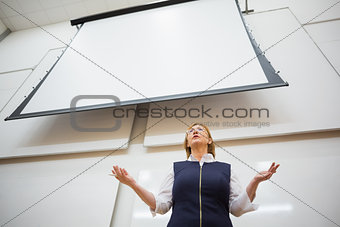 Female teacher with projection screen in the lecture hall