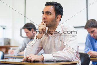 Mature students taking notes in classroom