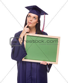 Thinking Female Graduate in Cap and Gown Holding Blank Chalkboar