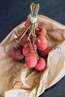 A bunch of Lychees on a paper bag