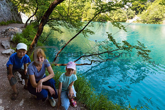 Family near summer azure  limpid  transparent lake (Plitvice, Cr