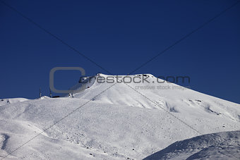 Off-piste slope with traces of skis at nice sunny day