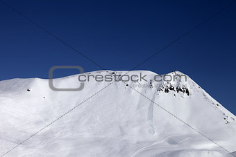 Off-piste slope with trace of skis, snowboarding and avalanche