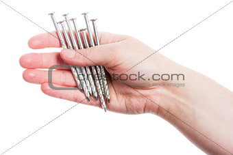 Hand holding handful of nails 