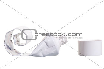 empty cosmetic tube with the lid open on a white background