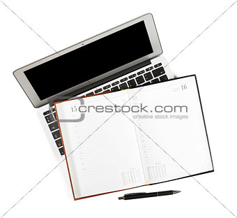 Blank notepad over laptop
