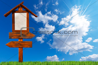 Double Directional Wooden Signs on Blue Sky