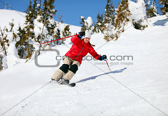 Girl skier moving down the slope