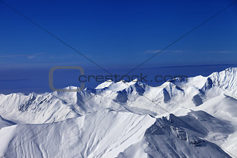 View on off-piste slopes and blue sky at nice sunny day