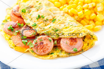 Omelet with sausage, tomato and herbs