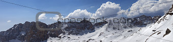 Panorama of snowy mountains in nice sunny day