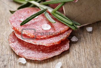 italian salami sausage slices with rosemary and sea salt
