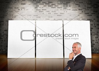 Mature thoughtful businessman crossing arms