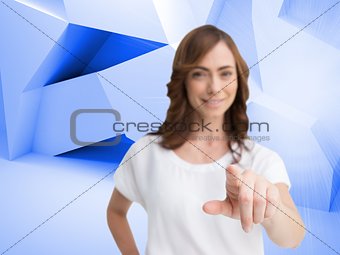 Attractive businesswoman looking and pointing at camera