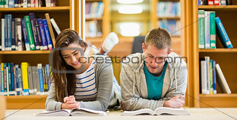 Students reading books on the library floor