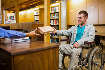 Student in wheelchair at the library counter