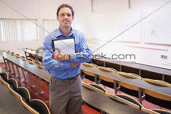 Male teacher with notepad in the lecture hall