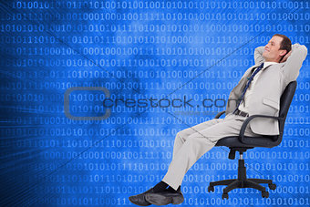 Composite image of side view of businessman in his chair