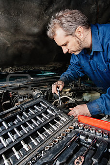 Mechanic fixing an engine