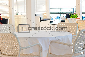 in the cafeteria wicker chairs and tables covered with cloth