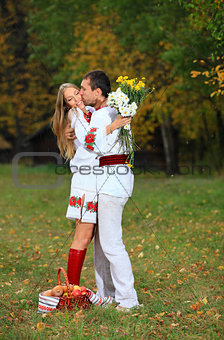 Young couple in Ukrainian style clothes outdoors