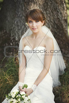 Beautiful bride posing in garden.
