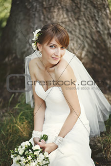 Happy bride posing in garden.