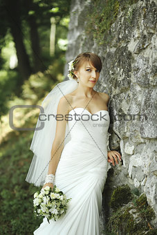 Happy bride posing in garden.