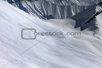 View on snowy off piste slope with trace from ski, snowboards an