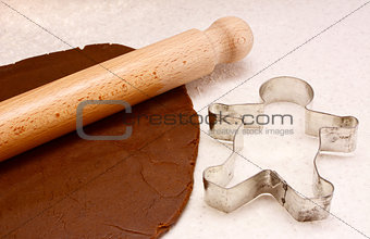 Gingerbread dough, rolling pin and cookie cutter