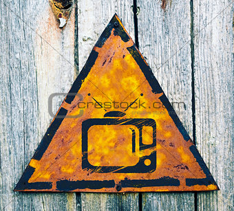 TV Set Icon on Rusty Warning Sign.