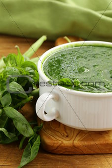 green cream soup of spinach and green peas in white bowl