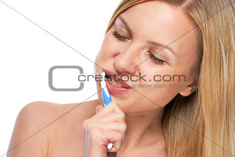 Portrait of happy teenage girl brushing teeth