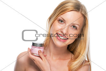 Portrait of happy teenage girl showing creme