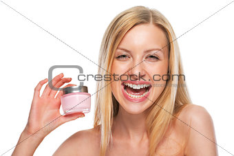 Portrait of smiling teenage girl showing creme