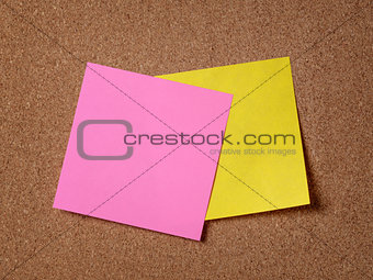 two reminder sticky notes on cork board