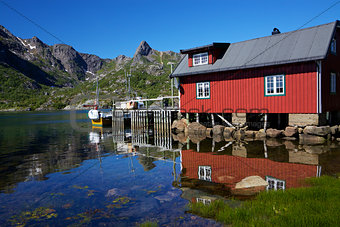 Fishing hut reflecting in fjord