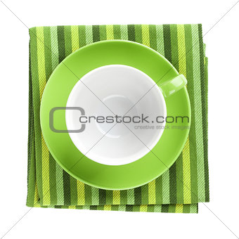 Green coffee cup over kitchen towel