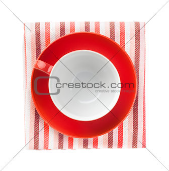 Red coffee cup over kitchen towel
