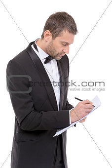 Handsome man in a bow tie writing notes