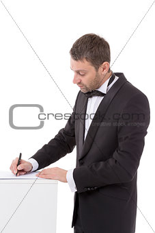 Man in a bow tie completing a form