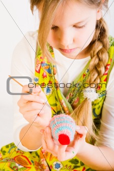 Young girl painting eggs for easter