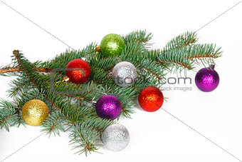 Many colored balls on the fir branch of Christmas tree