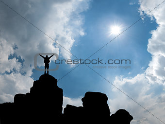 Happy man standing at mountain top