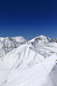 Off-piste slope and blue clear sky in sun day
